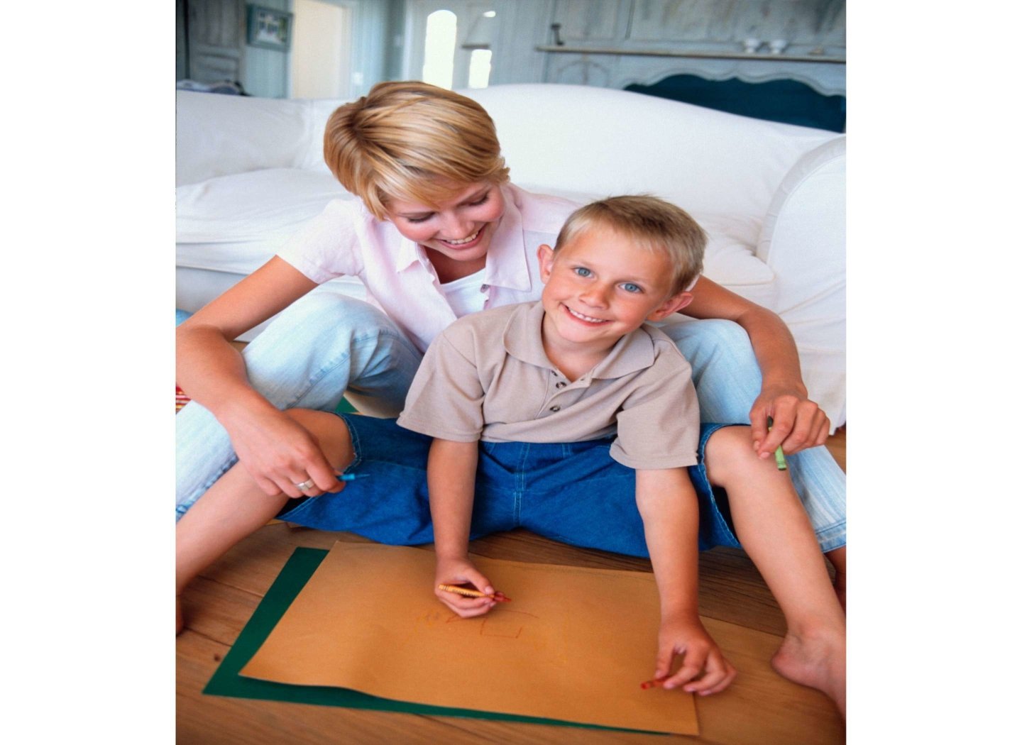 mother-and-son-drawing-on-canvas-on-floor