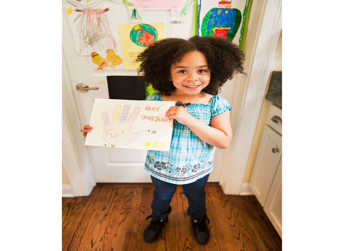smiling-kid-holding-drawing
