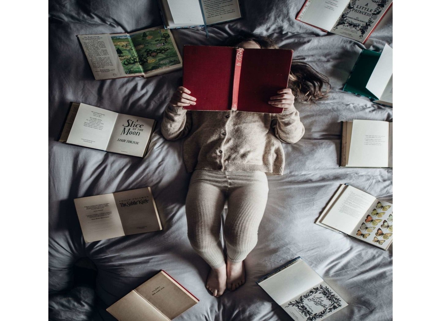 child-reading-a-book-on-bed