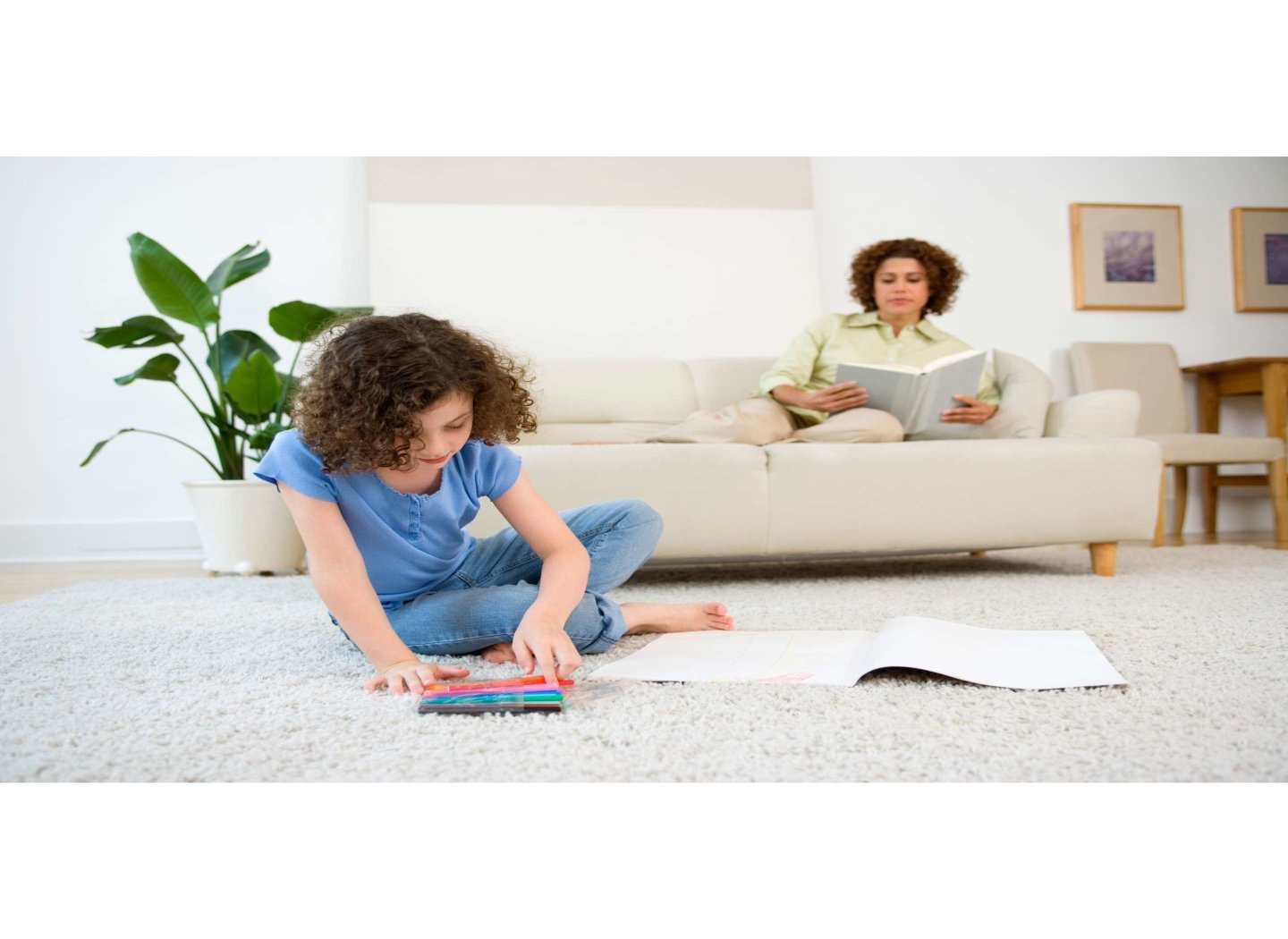 mother-reading-while-daughter-drawing