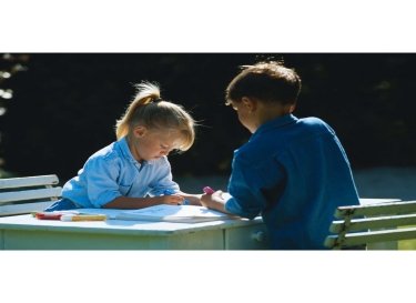 two-kids-drawing-on-table