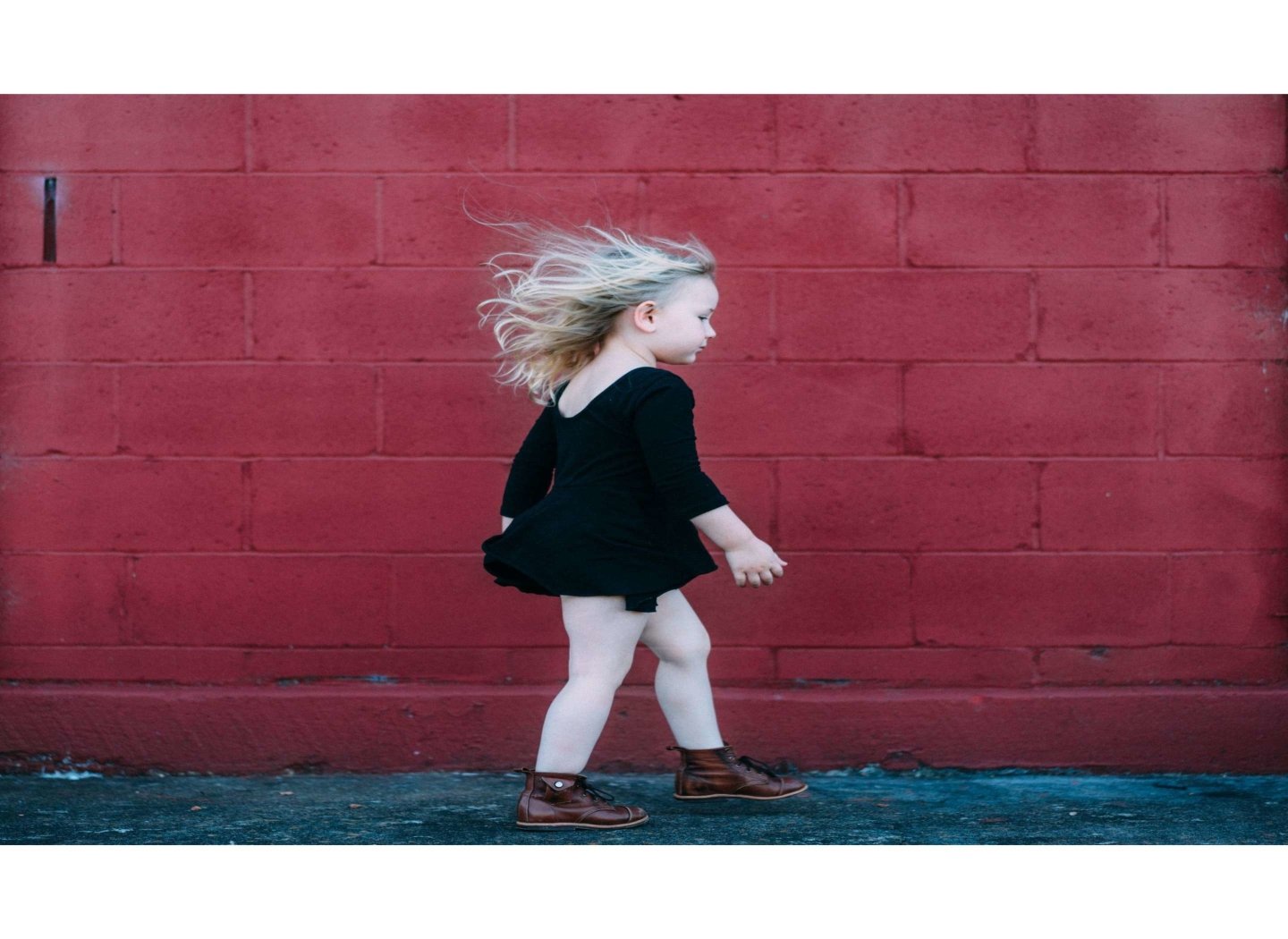 small-girl-infront-of-red-wall