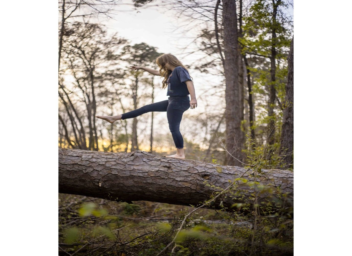 girl-dancing-on-tree-trunk