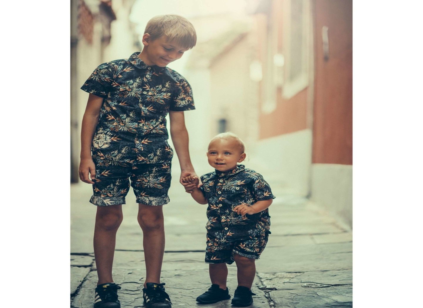 brother-holding-sibling-hand